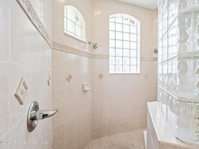 a bathroom with a window and a shower