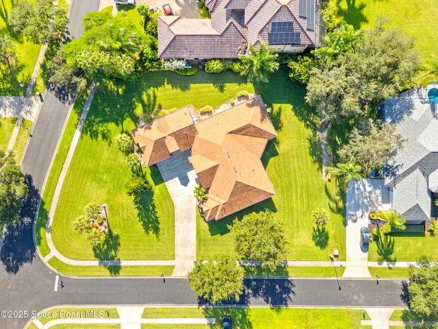 an aerial view of a swimming pool with outdoor seating