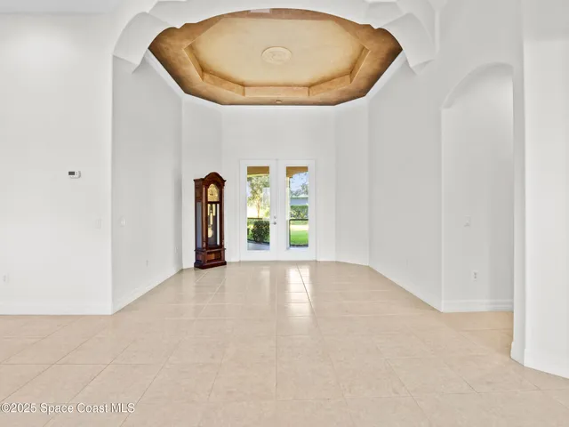 an empty room with a window and mirror