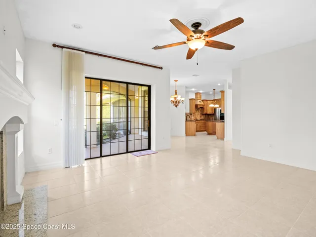 a view of a livingroom with a ceiling fan and window