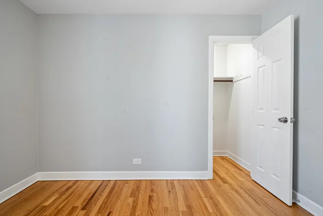 a view of a room with wooden floor and a staircase