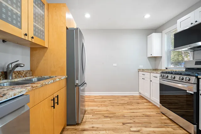 a kitchen with stainless steel appliances granite countertop a stove and a sink