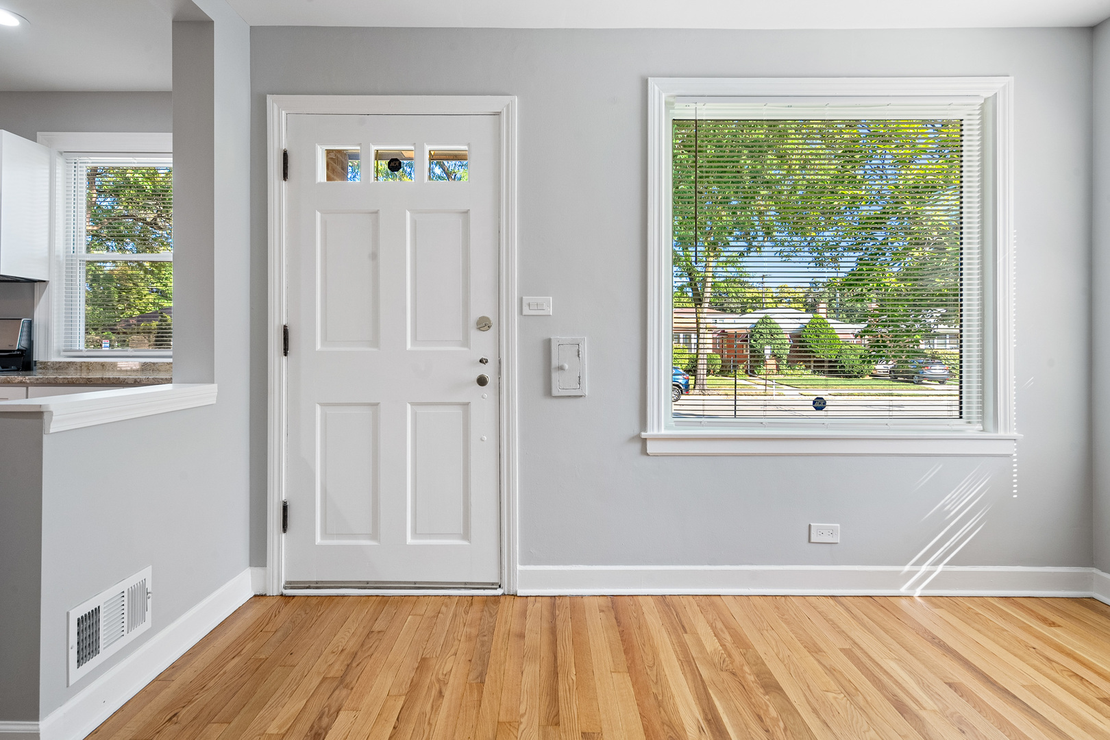 604 Dodge Avenue Evanston, IL 60202 - Photo 7 of 26 a view of a hallway with wooden floor and a window