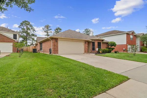 a front view of house with yard and green space