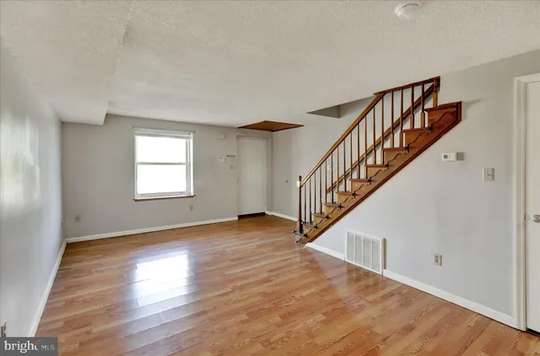 a view of an entryway with wooden floor