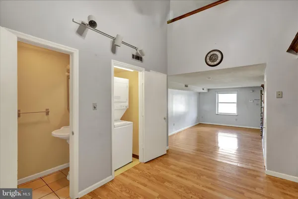 a view of a hallway with wooden floor
