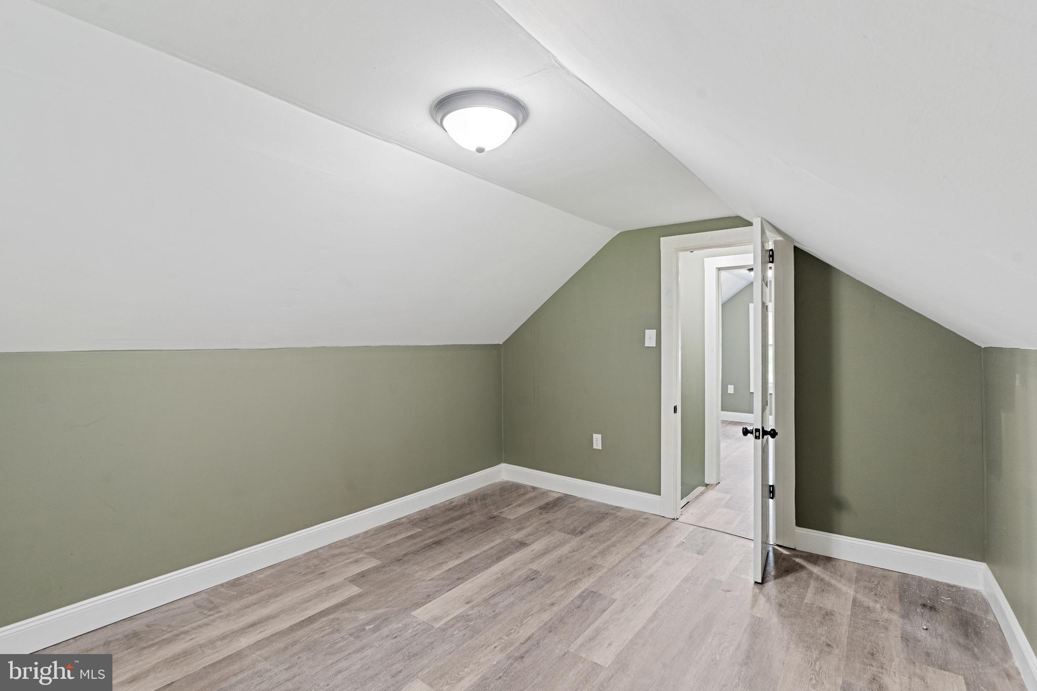 22 Davis Avenue Salem, NJ 08079 - Photo 15 of 25 an empty room with wooden floor and mirror