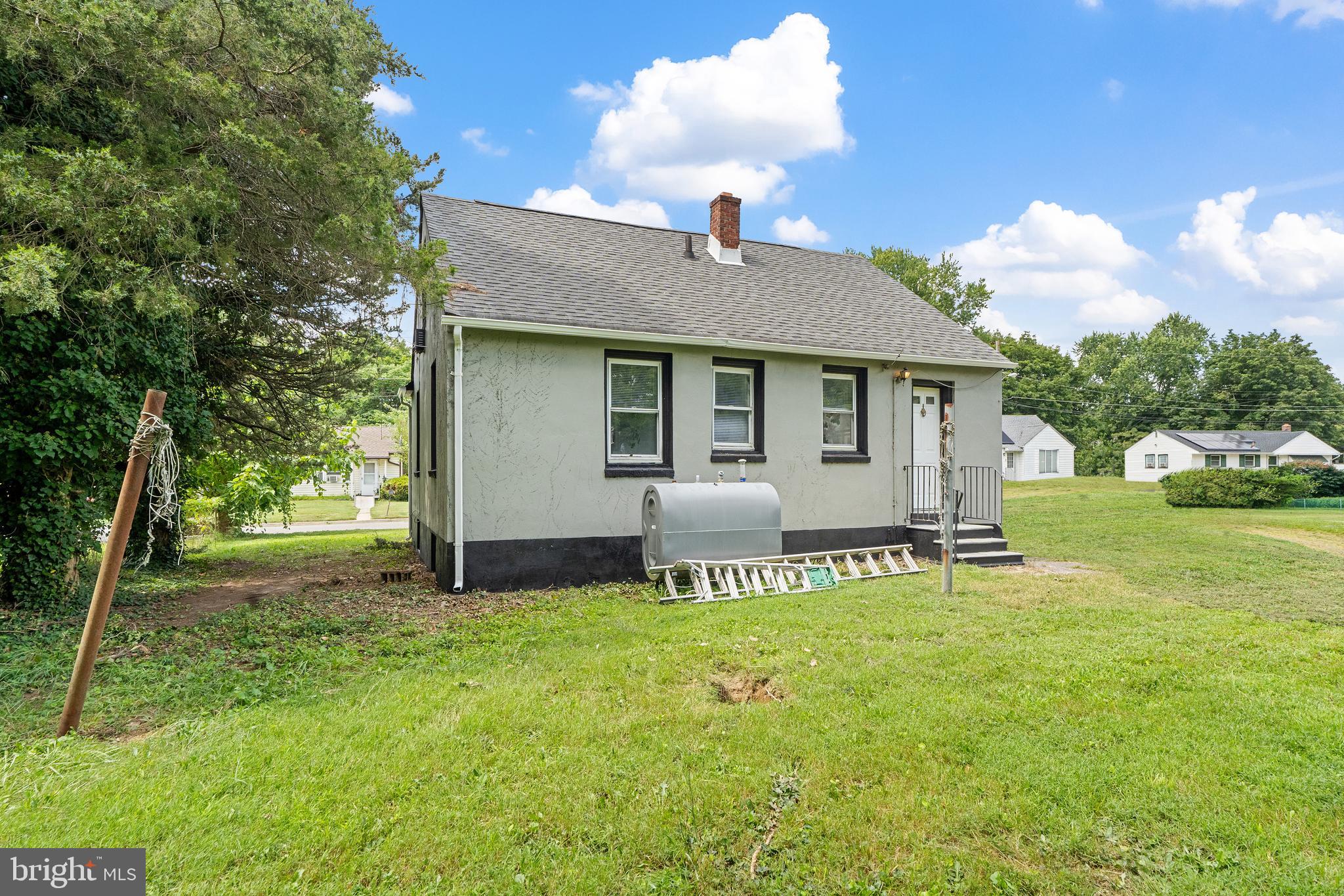 22 Davis Avenue Salem, NJ 08079 - Photo 23 of 25 a house view with a sitting space and garden