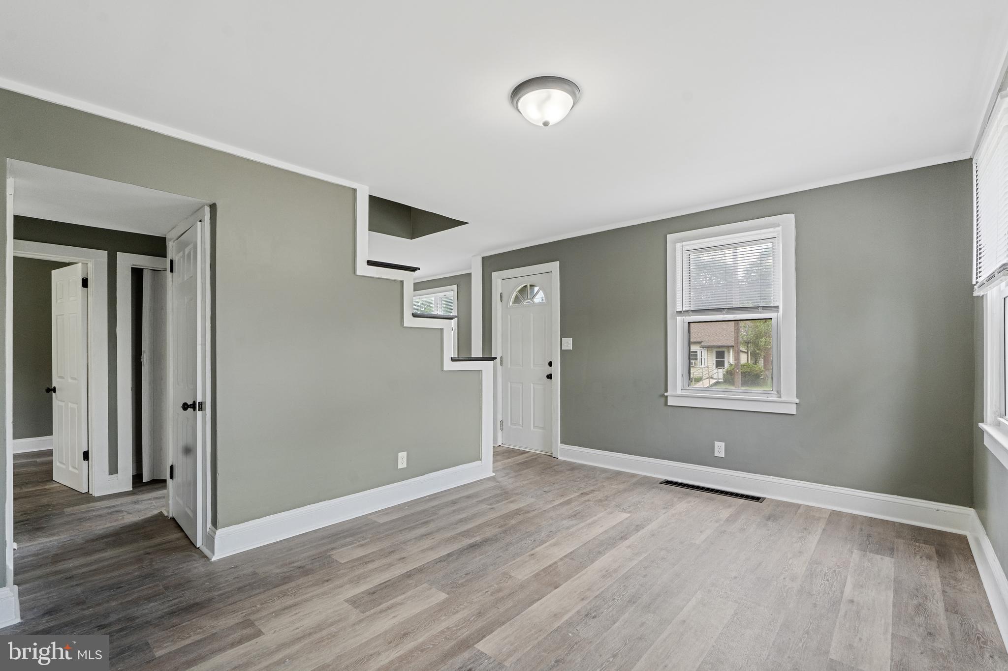 22 Davis Avenue Salem, NJ 08079 - Photo 5 of 25 an empty room with wooden floor and windows