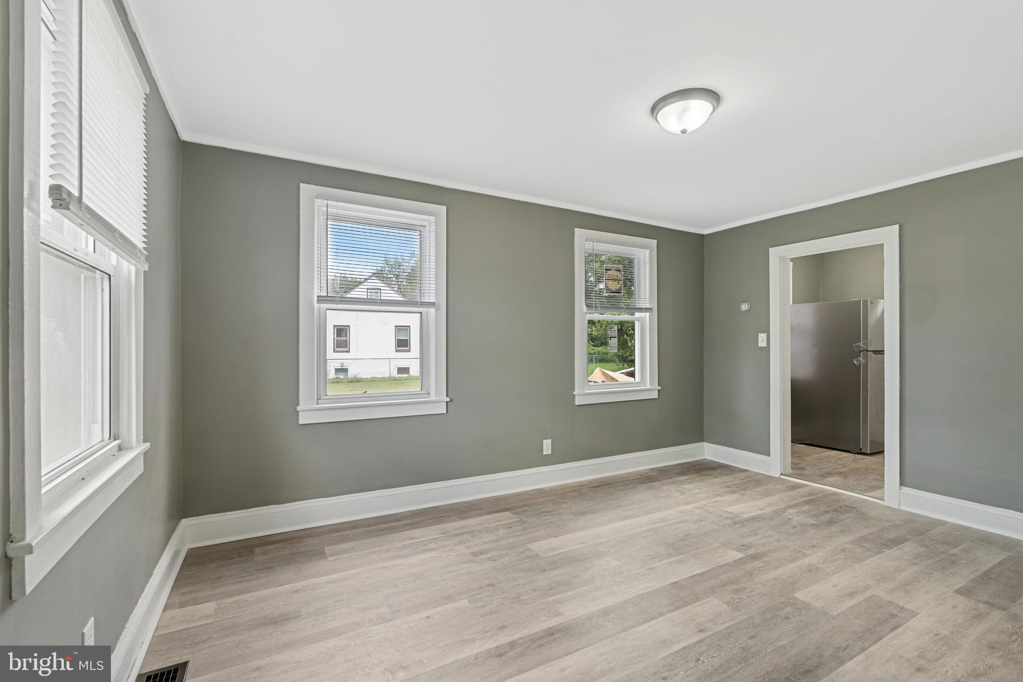 22 Davis Avenue Salem, NJ 08079 - Photo 7 of 25 a view of an empty room with wooden floor and a window