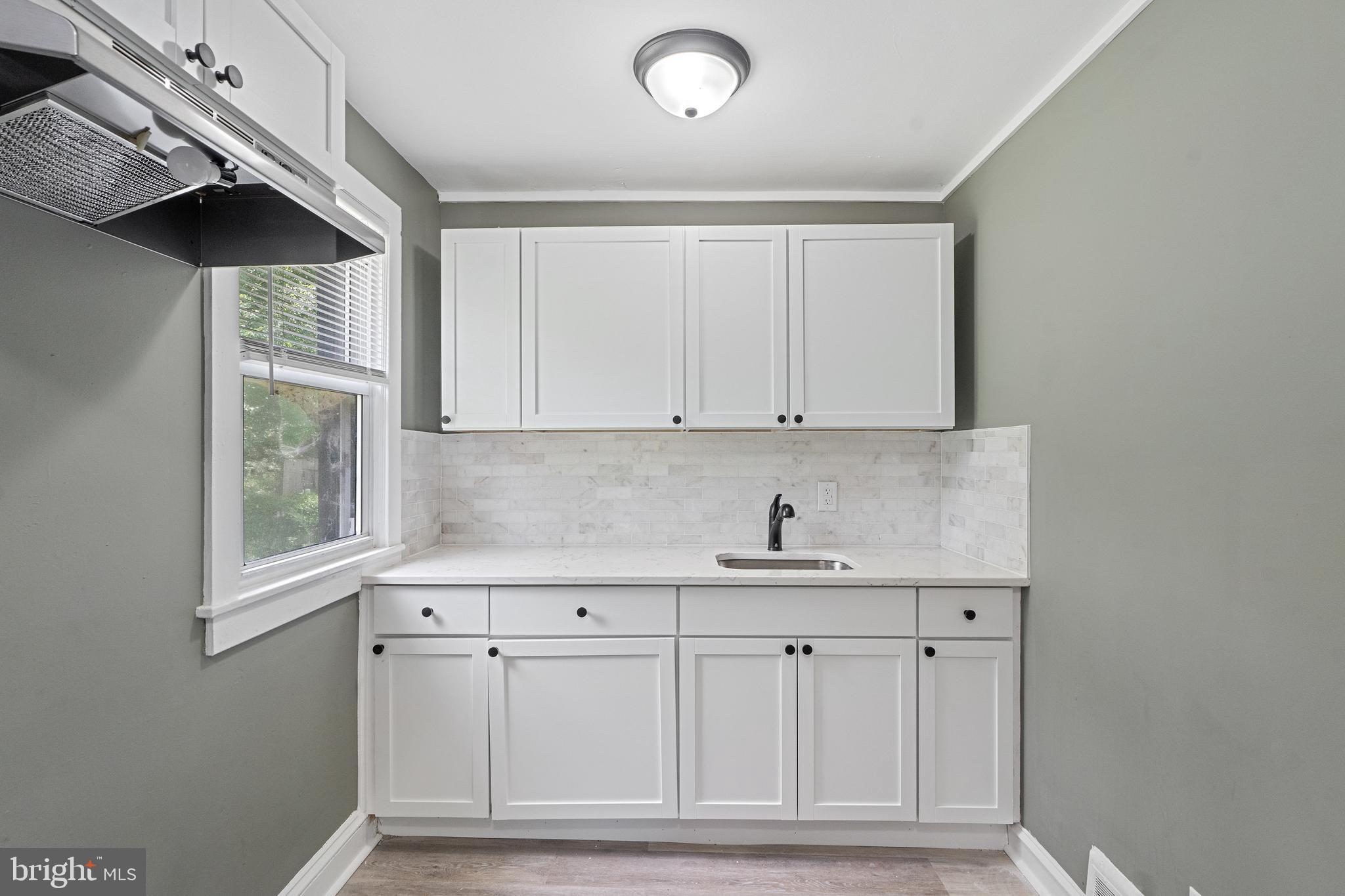 22 Davis Avenue Salem, NJ 08079 - Photo 9 of 25 a kitchen with white cabinets and window