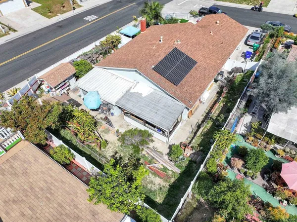 an aerial view of a house with a yard and potted plants