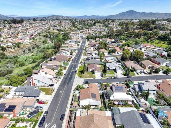 an aerial view of a house with garden space and street view