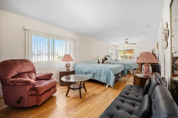 a bedroom with furniture and wooden floor