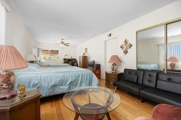 a spacious bedroom with a bed couch and a window