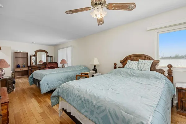 a bedroom with two beds and a chandelier