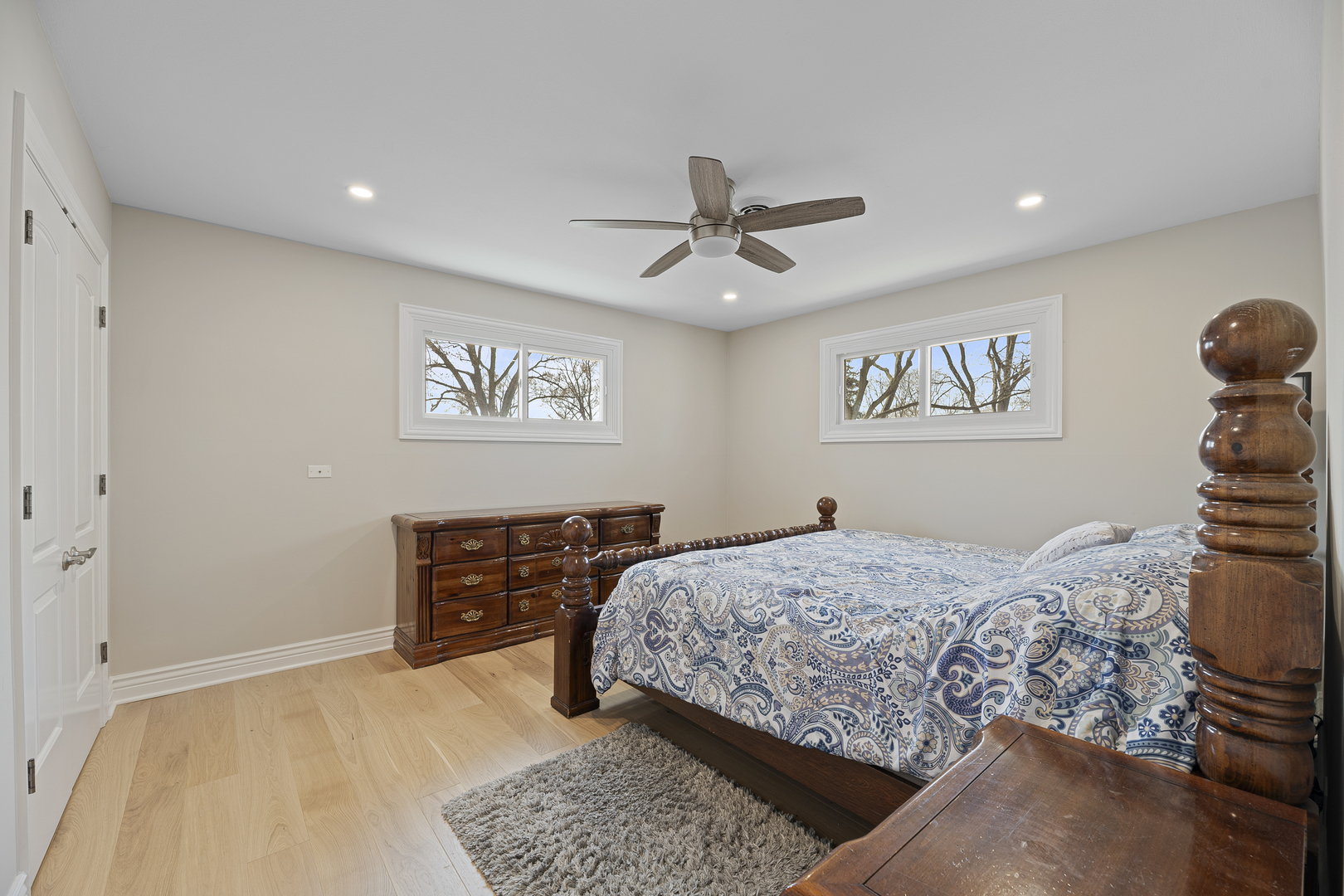 3348 Ralmark Lane Glenview, IL 60026 - Photo 14 of 36 a bedroom with a large bed and a chandelier