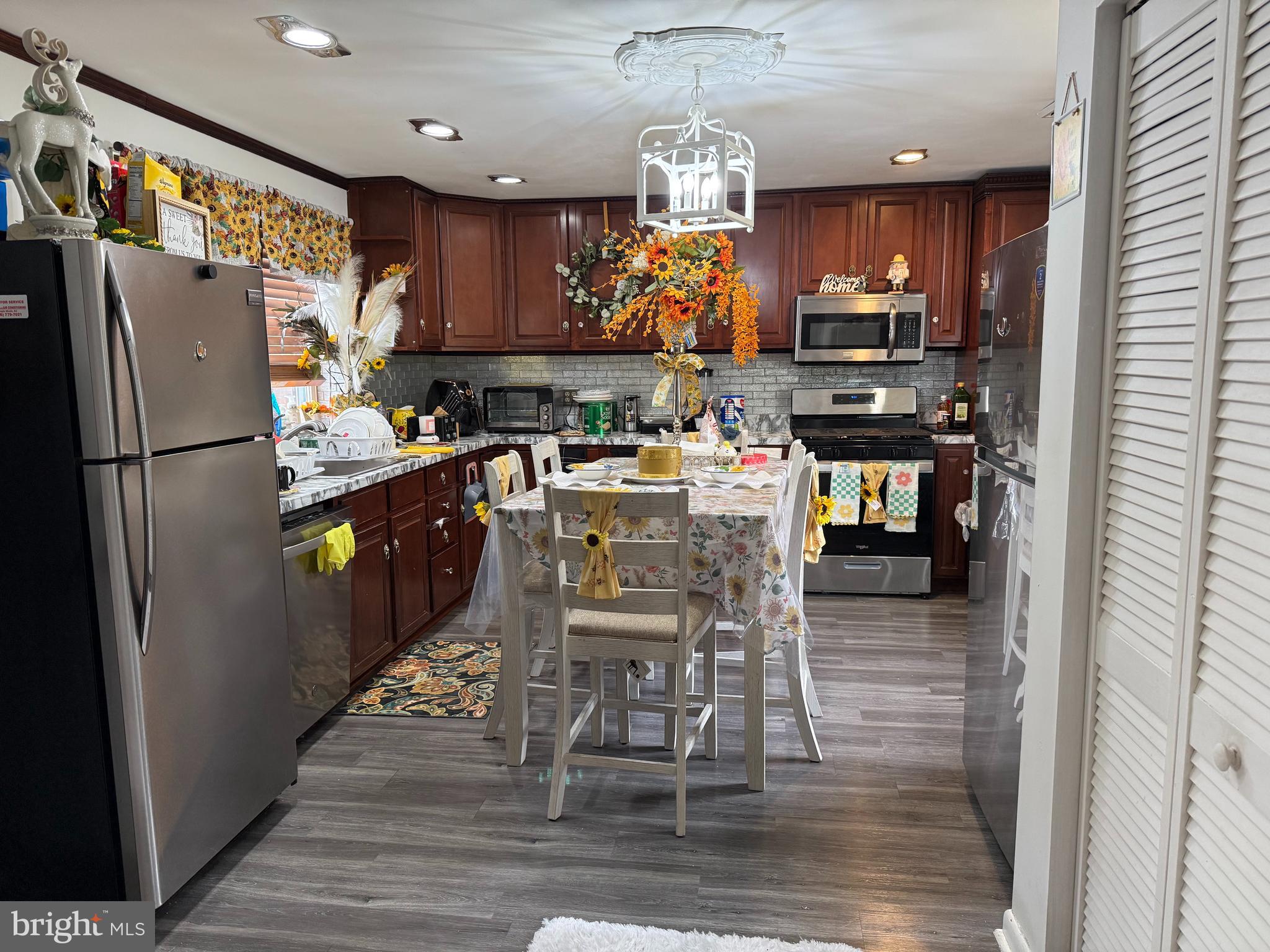 305 Lincoln Avenue Maple Shade, NJ 08052 - Photo 4 of 23 a kitchen with granite countertop a refrigerator a stove top oven a sink and chairs
