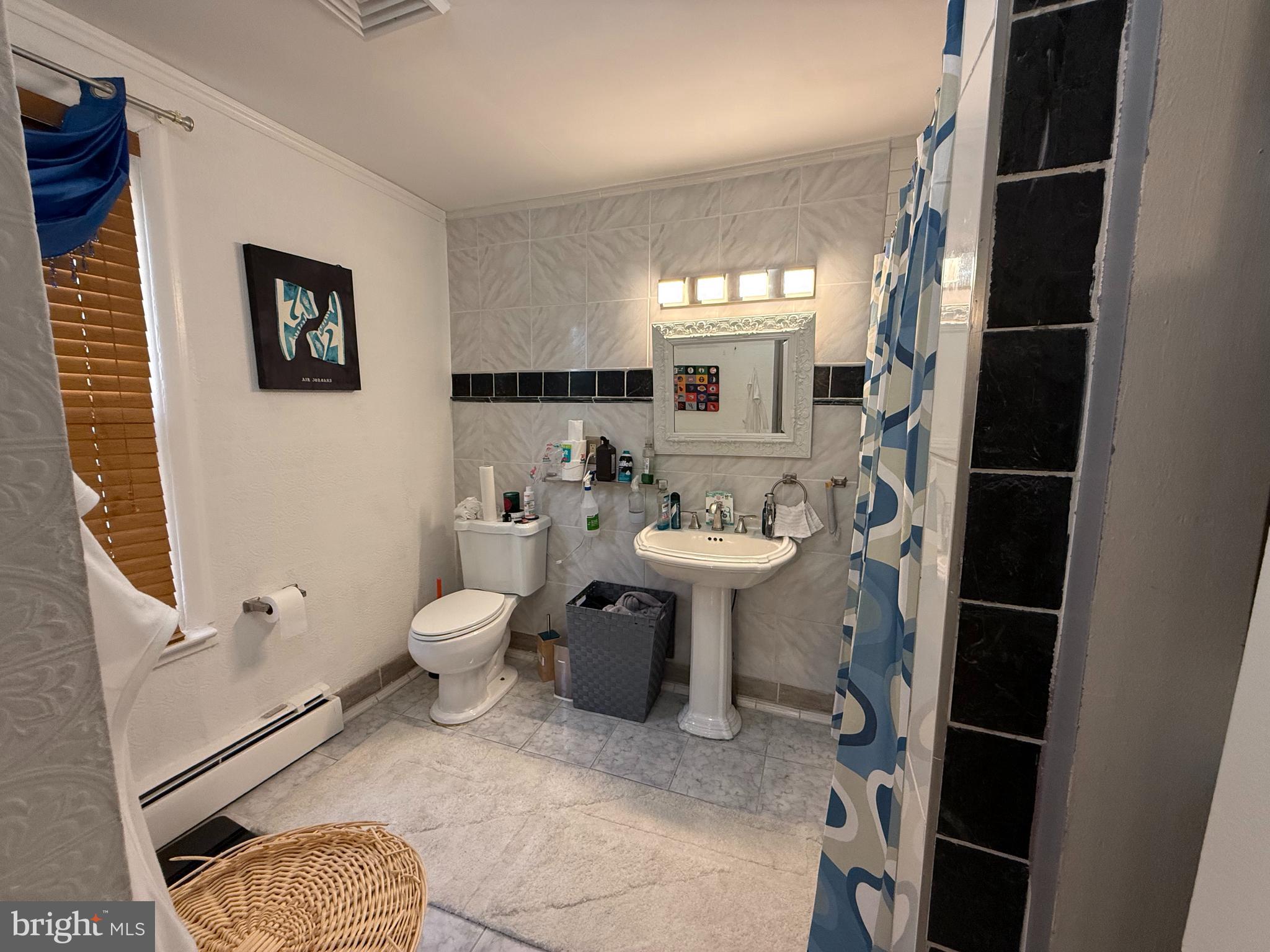 305 Lincoln Avenue Maple Shade, NJ 08052 - Photo 9 of 23 a bathroom with a toilet a sink and mirror