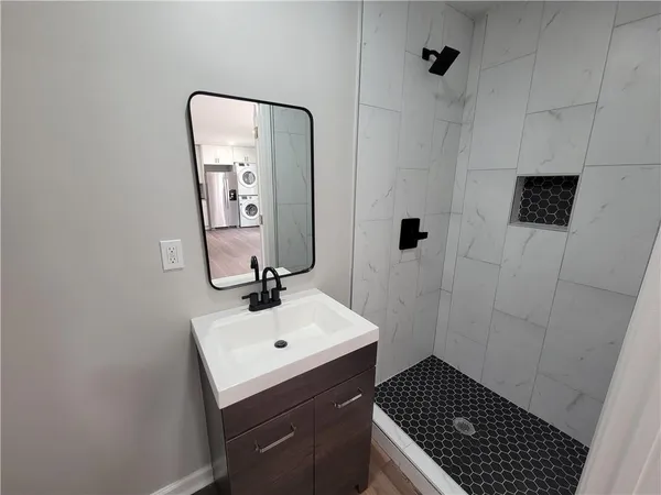 a bathroom with a sink a toilet and mirror
