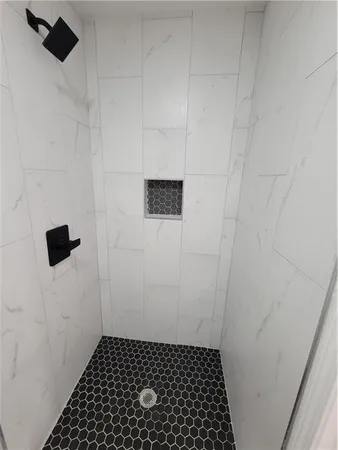 a bathroom with a shower and a toilet