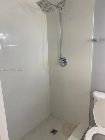 a bathroom with a shower toilet and sink