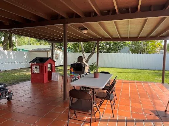 a patio with a patio table and chairs