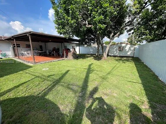 a view of house with a backyard