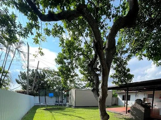 a view of a backyard with large trees