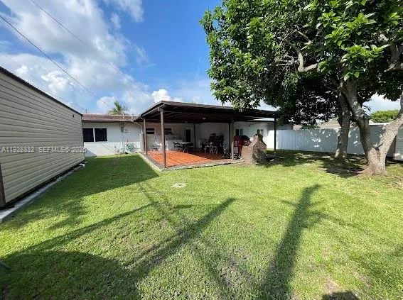 a view of a house with a yard patio and fire pit