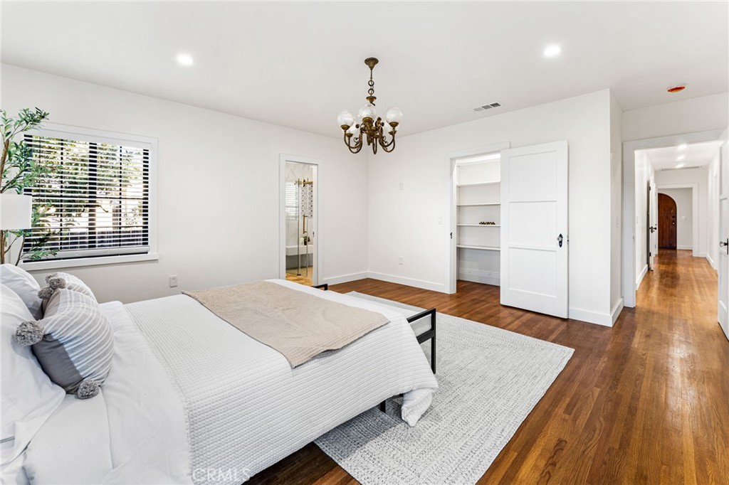 1201 Montecito Drive Montecito Heights, CA 90031 - Photo 37 of 71 a bedroom with a bed and a wooden floor