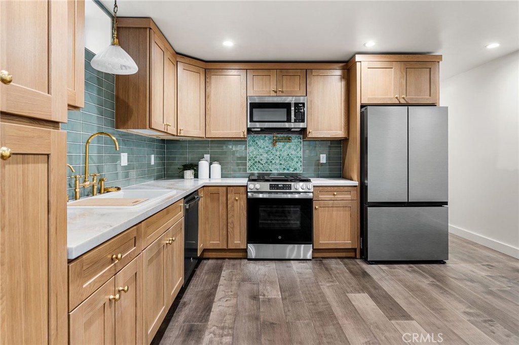 1201 Montecito Drive Montecito Heights, CA 90031 - Photo 46 of 71 a kitchen with stainless steel appliances granite countertop a refrigerator sink and stove