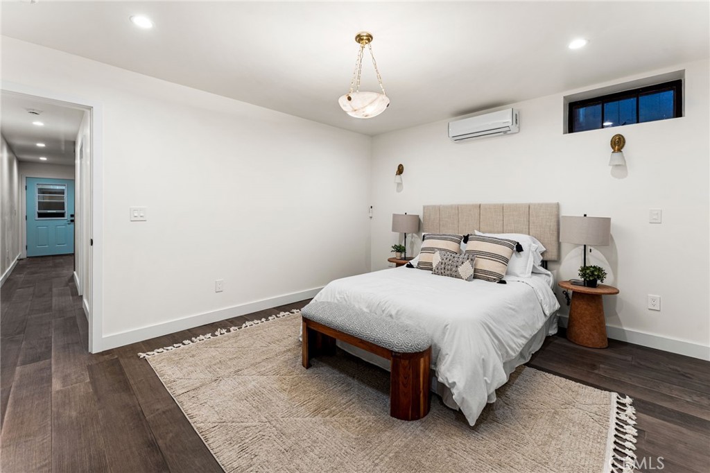 1201 Montecito Drive Montecito Heights, CA 90031 - Photo 49 of 71 a bedroom with a bed and wooden floor