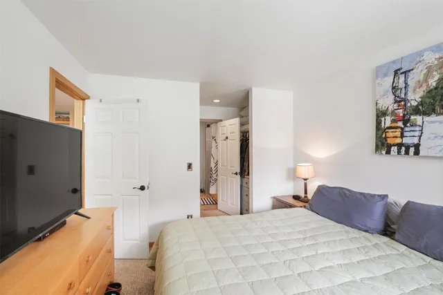 a spacious bedroom with a bed and a couch