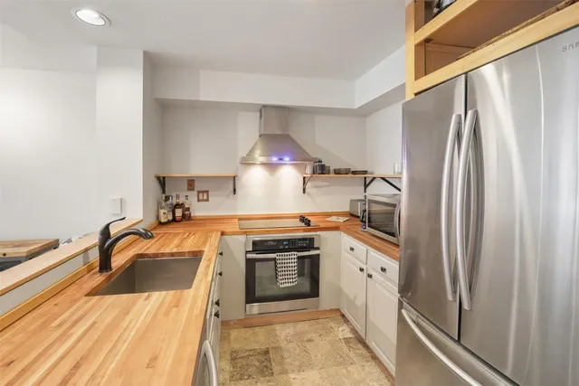 a kitchen with a sink a stove and refrigerator