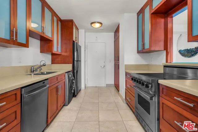 a kitchen with stainless steel appliances granite countertop a stove and a sink