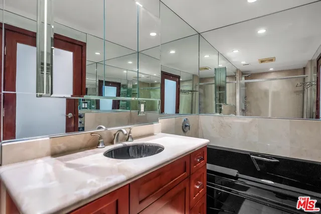 a kitchen with kitchen island a sink and a stove with wooden floor