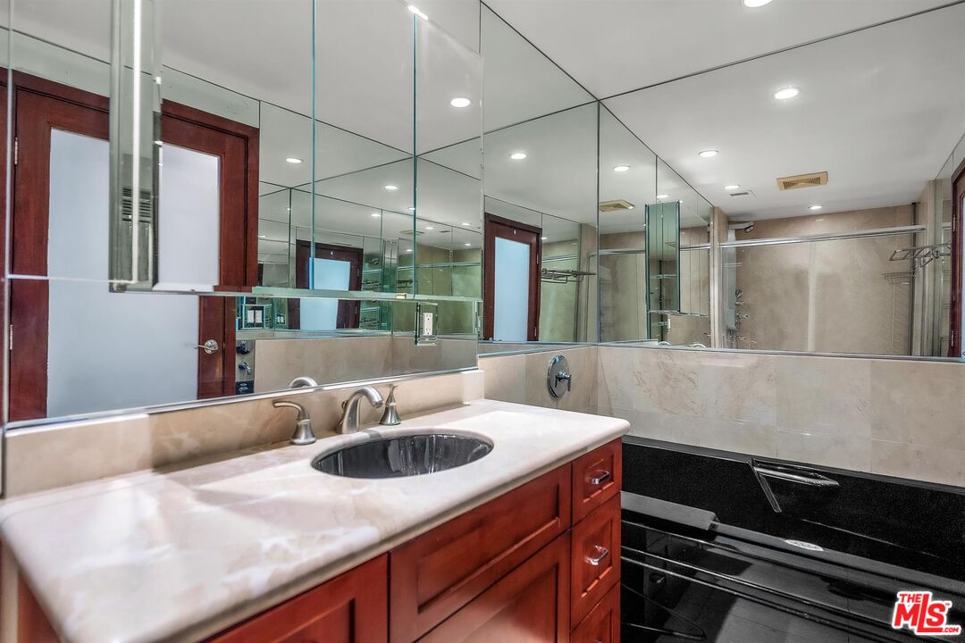 865 Comstock Avenue, Unit 4C Los Angeles, CA 90024 - Photo 17 of 26 a kitchen with kitchen island a sink and a stove with wooden floor