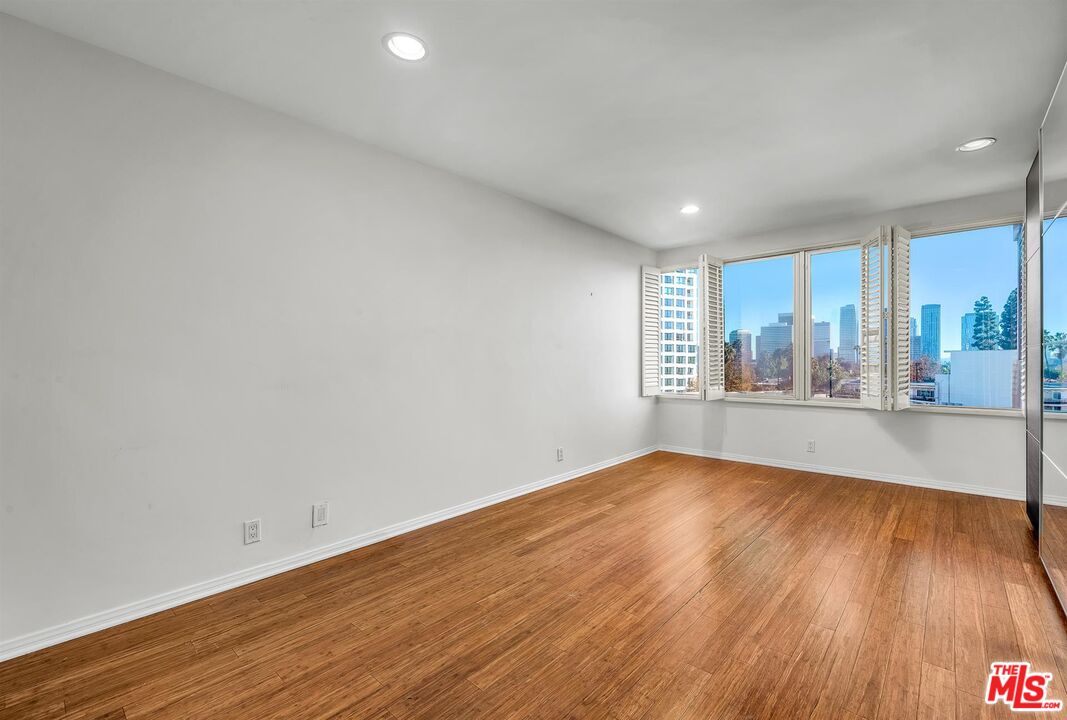 865 Comstock Avenue, Unit 4C Los Angeles, CA 90024 - Photo 21 of 26 a view of an empty room with wooden floor and a window