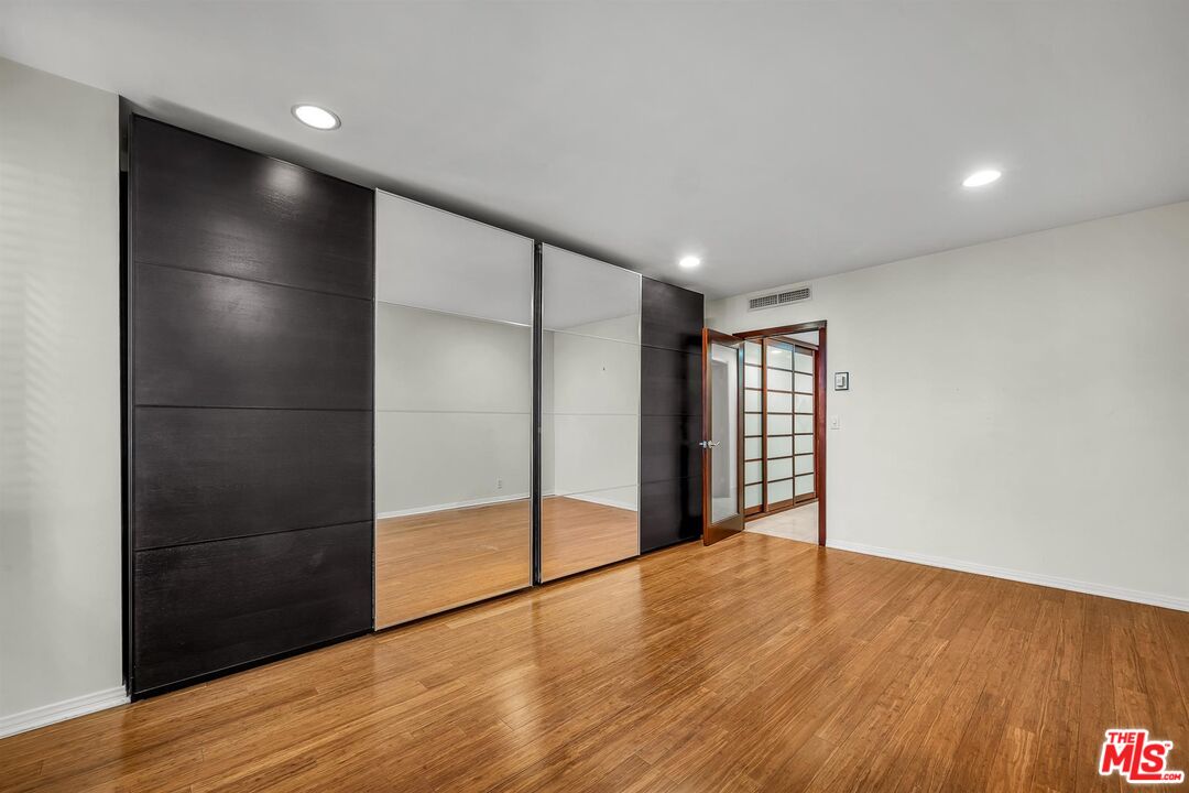 865 Comstock Avenue, Unit 4C Los Angeles, CA 90024 - Photo 22 of 26 a view of an empty room with wooden floor and window