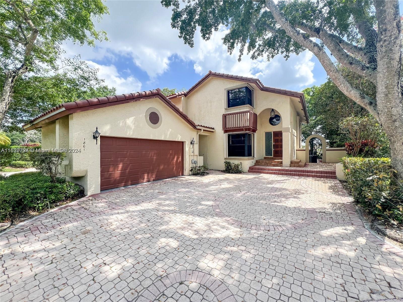 1801 Monte Carlo Way, Unit 23 Coral Springs, FL 33071 - Photo 1 of 62 a front view of a house with a yard and garage
