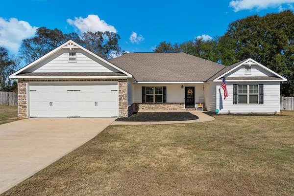 a front view of a house with a yard and garage