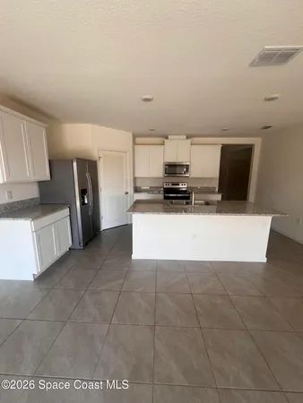 a kitchen with a sink and a stove