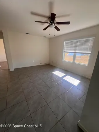 a view of empty room with a kitchen