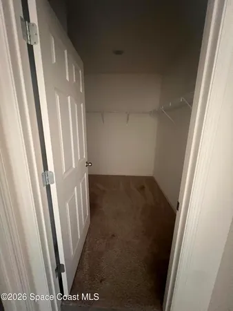 a view of an empty room and a window