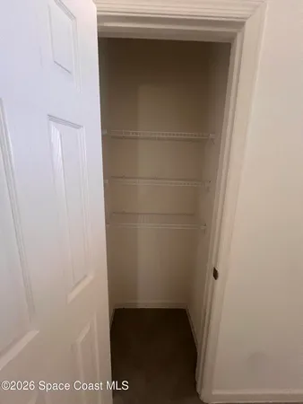 a large white kitchen with a sink and dishwasher a stove top oven with wooden floor