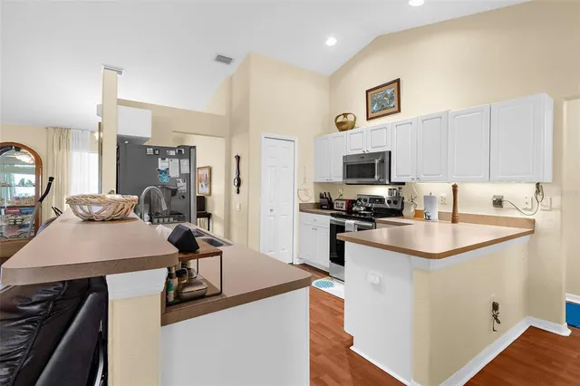 a kitchen with a sink stove and refrigerator