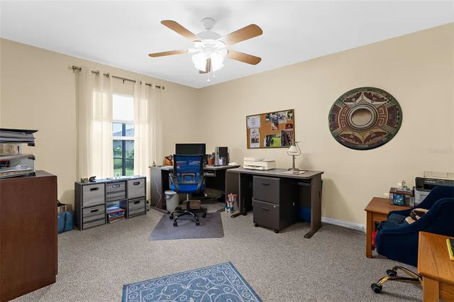 a view of a livingroom with workspace and a window