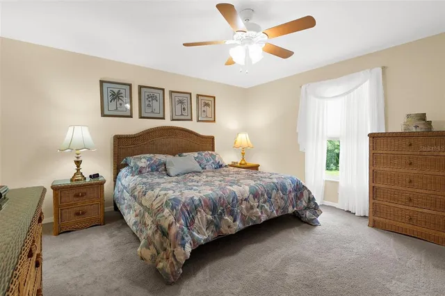 a spacious bedroom with a bed and a window