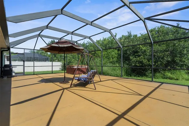 a patio with glass top table and chairs